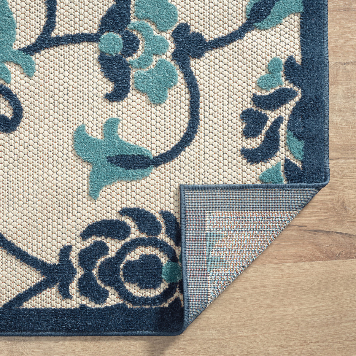 Ox Bay Blue Coastal Floral Filigree Hi-Low Indoor/Outdoor Area Rug - side angle view