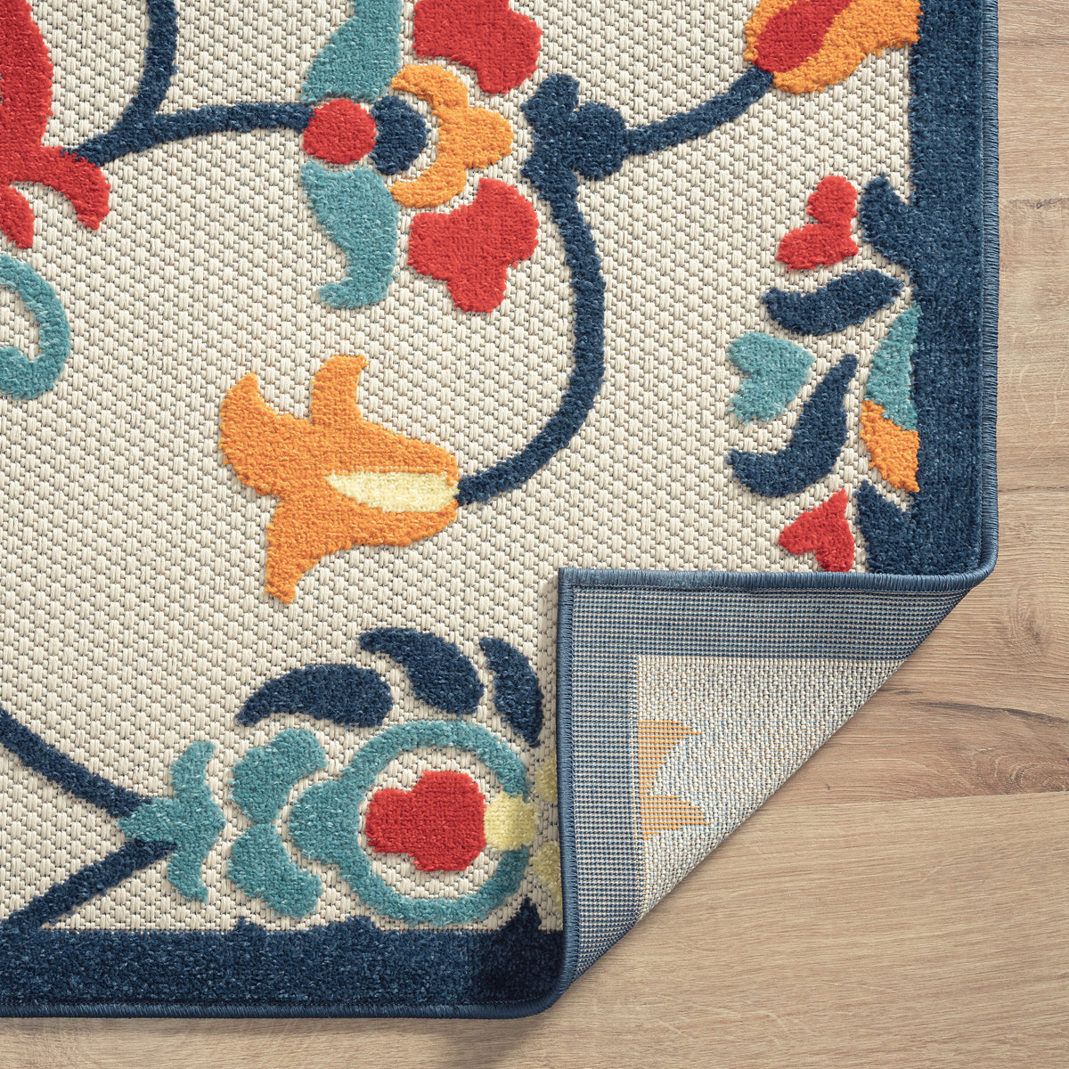 Ox Bay Orange Coastal Floral Filigree Hi-Low Indoor/Outdoor Area Rug - side angle view