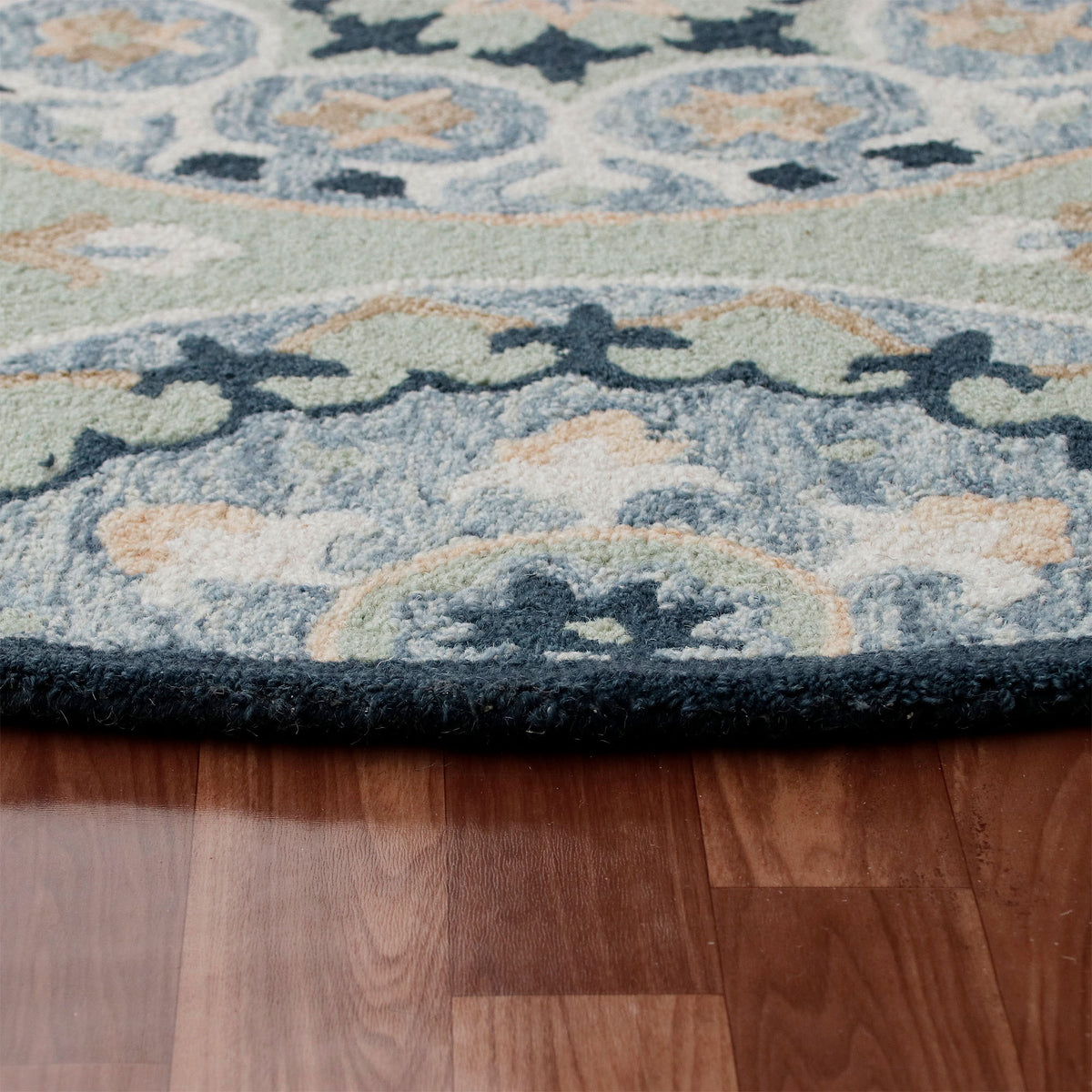 RugsA Sage/Blue Suzani Wool Round Rug - side angle view