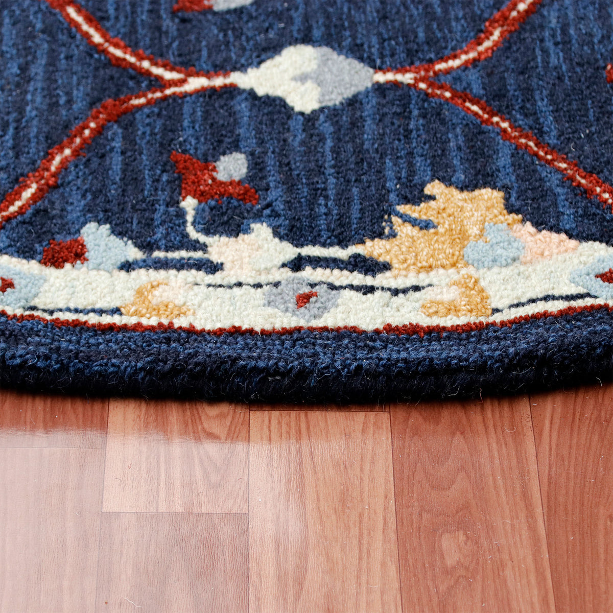 RugsA Navy/Red Trellis Wool Round Rug - side angle view
