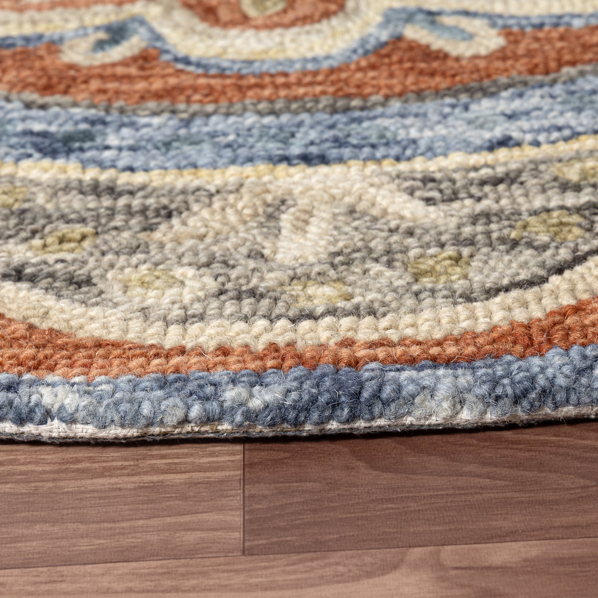 Rust Floral Farmhouse Hand-Woven Wool Indoor Area Rug - side angle view