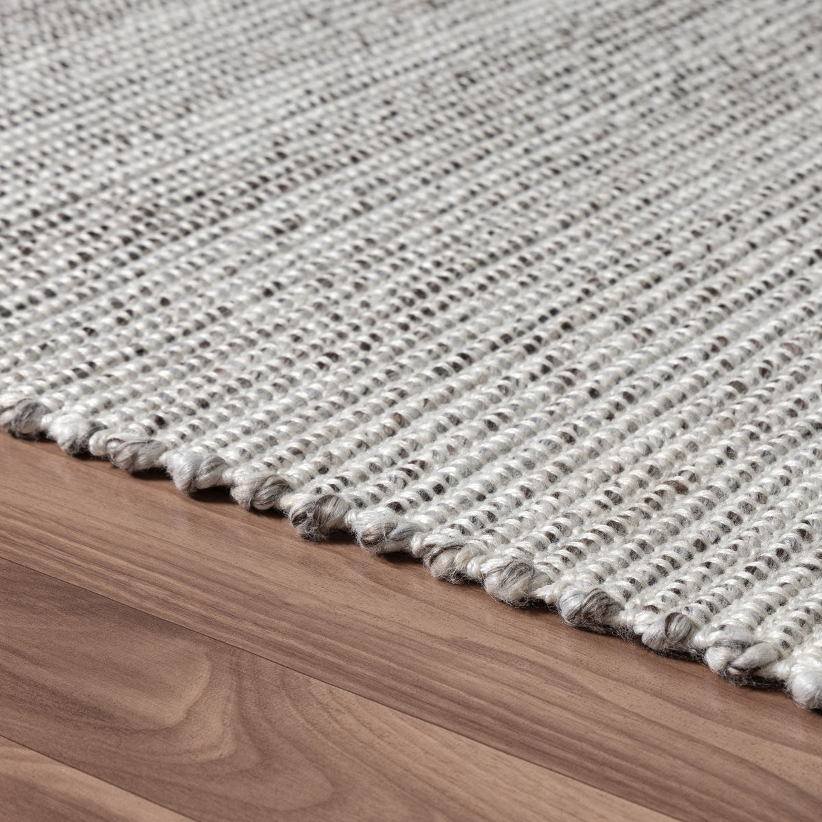 Brown/Ivory Rustic Solid Hand-Woven Polyester Indoor Area Rug - side angle view
