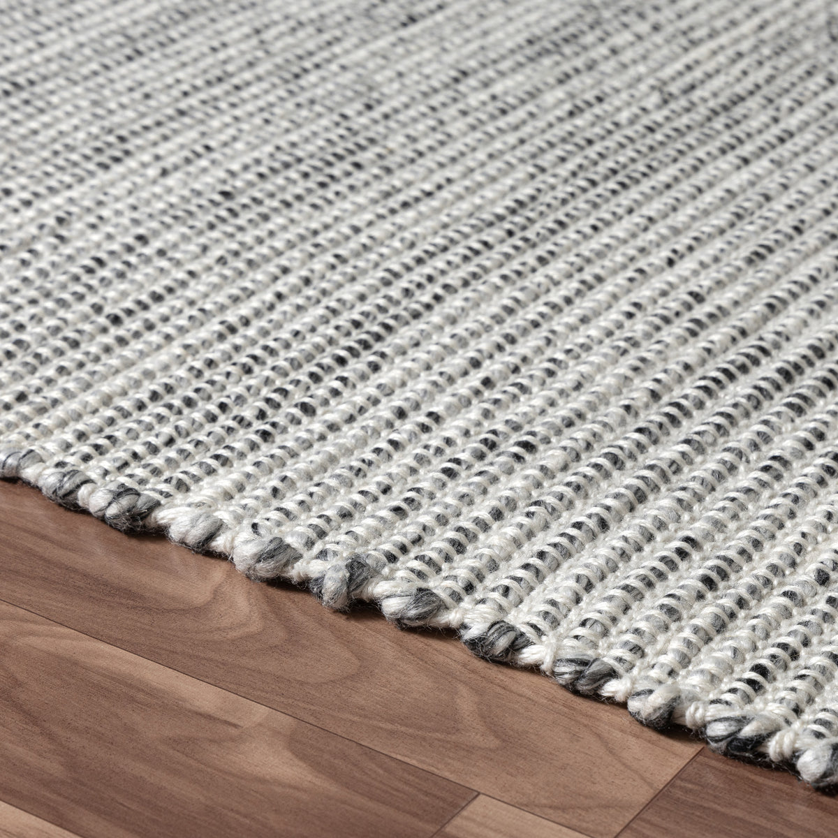 Silver/Ivory Contemporary Solid Hand-Woven Polyester Indoor Area Rug - side angle view