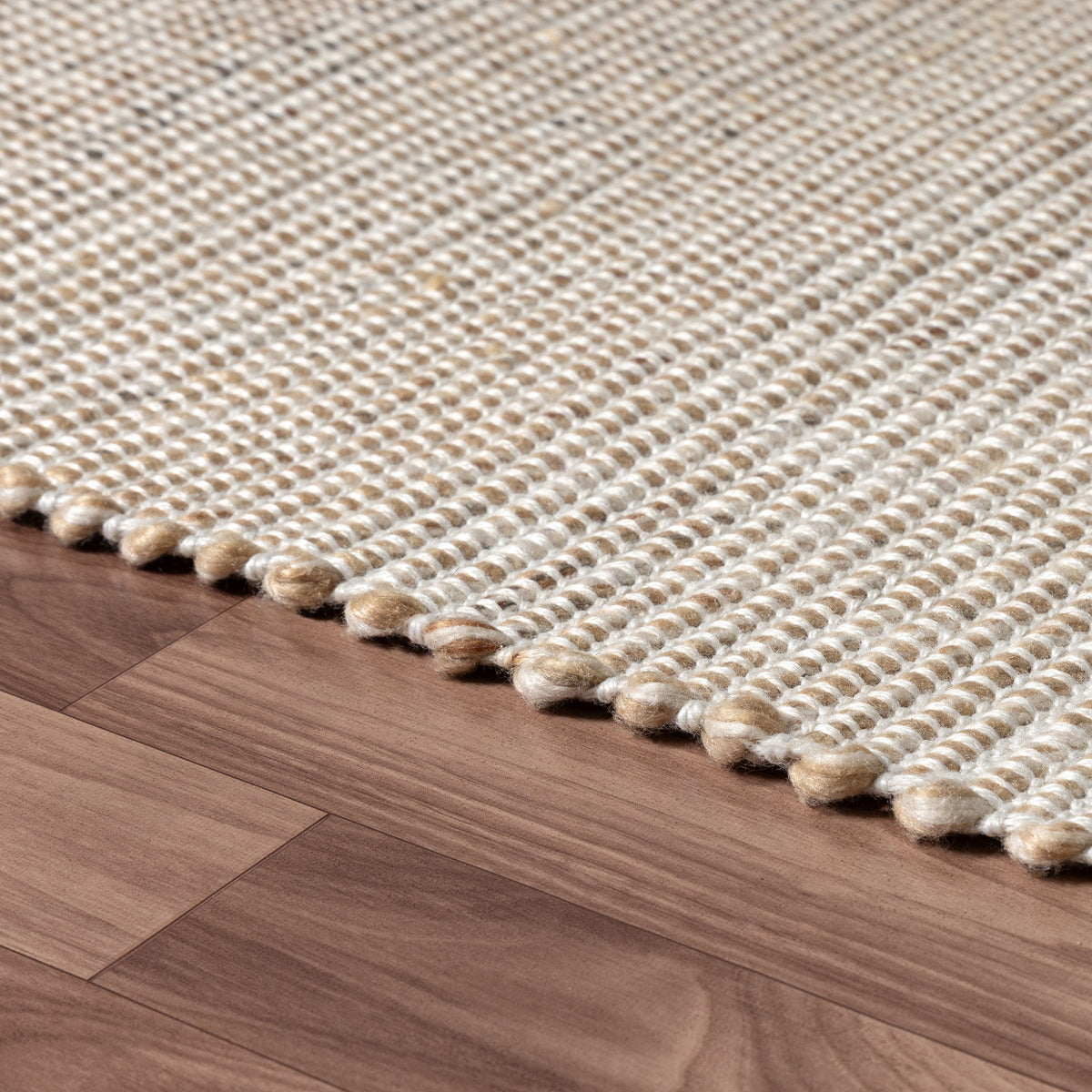 Beige/Ivory Contemporary Solid Hand-Woven Polyester Indoor Area Rug - side angle view